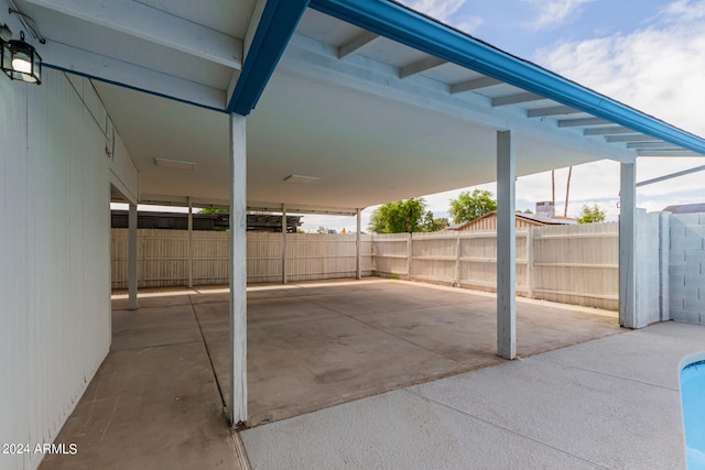 view of patio / terrace with a fenced backyard and a carport