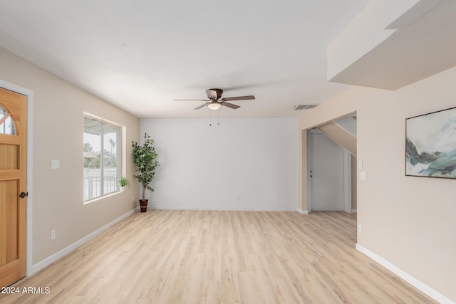 interior space featuring light wood finished floors, baseboards, visible vents, and a ceiling fan