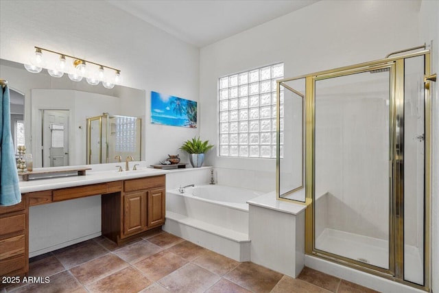 bathroom featuring vanity and independent shower and bath