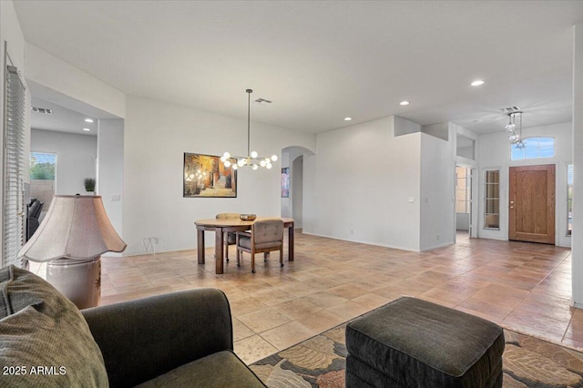 living room featuring light tile patterned floors and a chandelier