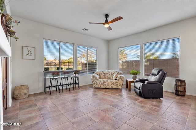 sitting room with ceiling fan and light tile patterned flooring