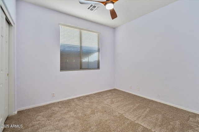 carpeted spare room with ceiling fan