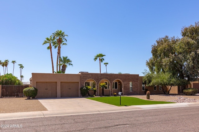 view of front of house with a garage and a front lawn