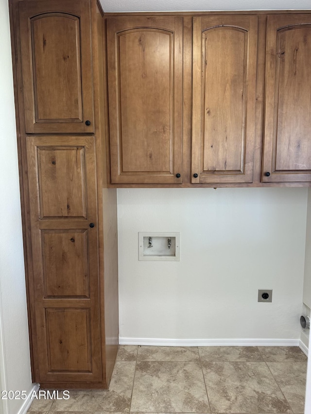 clothes washing area featuring cabinets, hookup for a washing machine, and electric dryer hookup