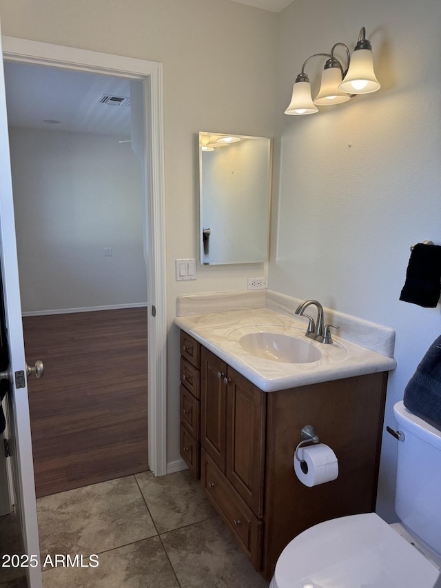 bathroom featuring vanity, tile patterned flooring, and toilet