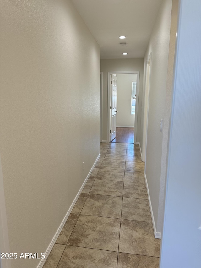 hall with light tile patterned flooring