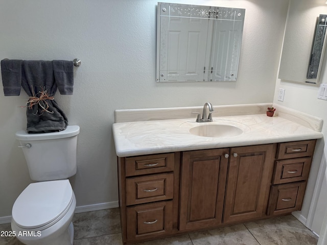 bathroom with vanity, tile patterned floors, and toilet