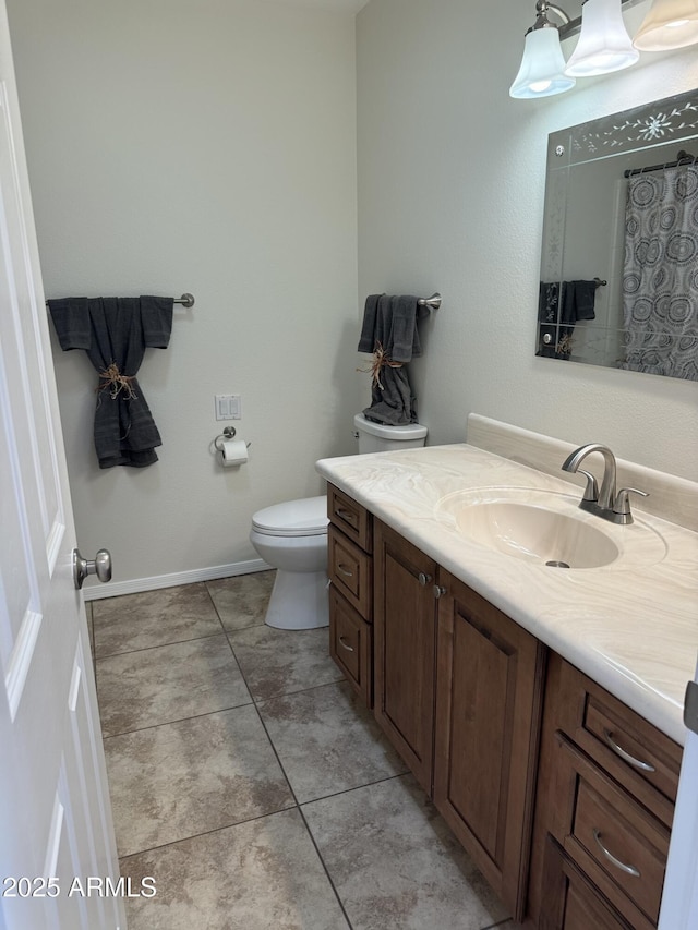 bathroom featuring vanity, toilet, and tile patterned flooring