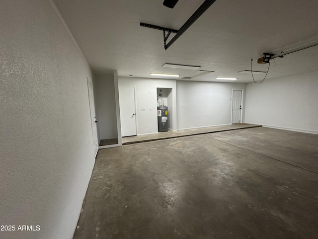 garage featuring water heater and a garage door opener