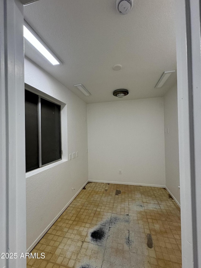 spare room featuring a textured ceiling