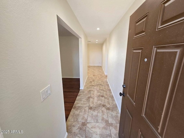 hall featuring light tile patterned floors