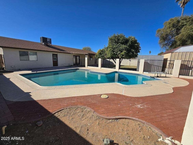 view of swimming pool featuring a patio and central air condition unit