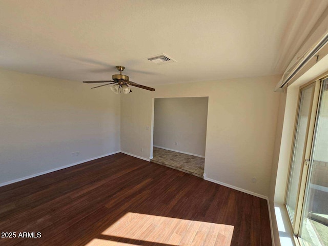 spare room featuring ceiling fan and dark hardwood / wood-style floors