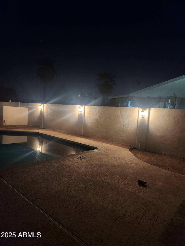 view of pool at night