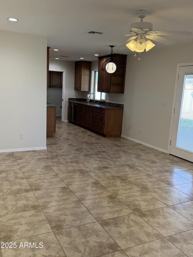 kitchen featuring ceiling fan and sink