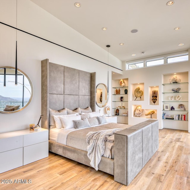 bedroom with recessed lighting, multiple windows, and light wood-type flooring