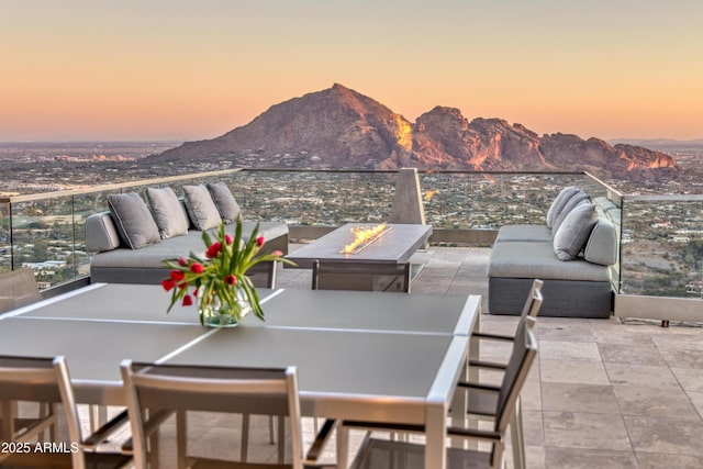 patio terrace at dusk featuring a mountain view and outdoor lounge area