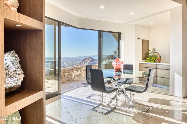 tiled dining space with recessed lighting and a mountain view