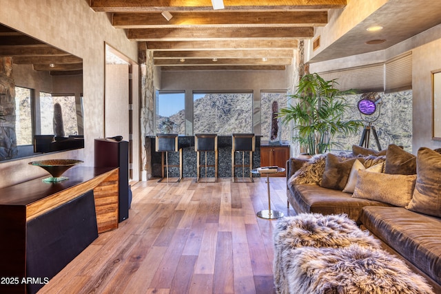 living room featuring hardwood / wood-style flooring and beamed ceiling