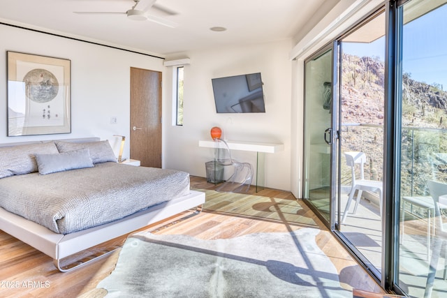 bedroom with access to outside, ceiling fan, and wood finished floors