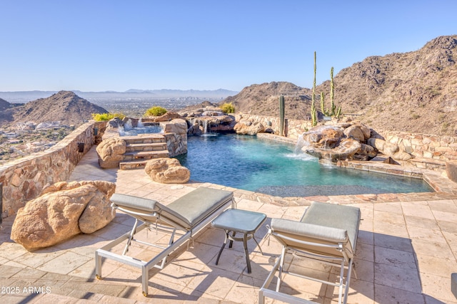 pool featuring a mountain view and a patio