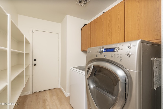 12424 N B St, El Mirage, AZ 85335 - laundry area featuring cabinet space, light wood-type flooring, washing machine and dryer, and baseboards