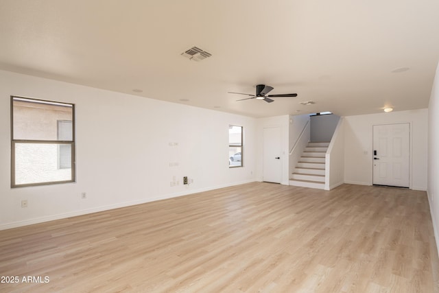 12424 N B St, El Mirage, AZ 85335 - unfurnished living room featuring stairs, light wood finished floors, a ceiling fan, and baseboards