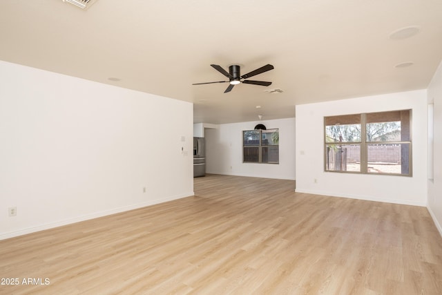 12424 N B St, El Mirage, AZ 85335 - unfurnished living room featuring light wood finished floors, ceiling fan, and baseboards