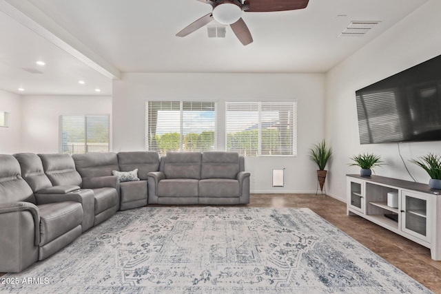 living room with ceiling fan and a healthy amount of sunlight