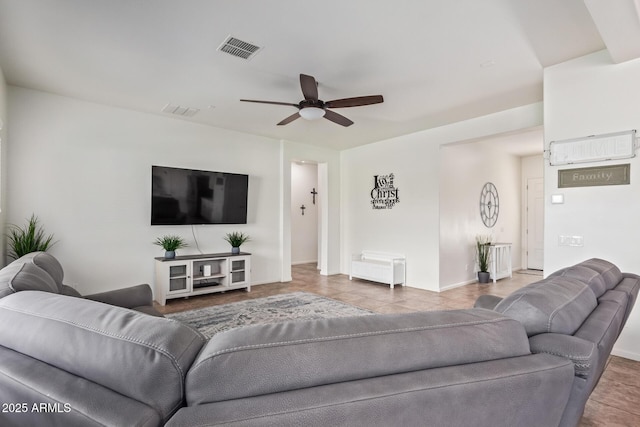 living room with ceiling fan and tile patterned floors