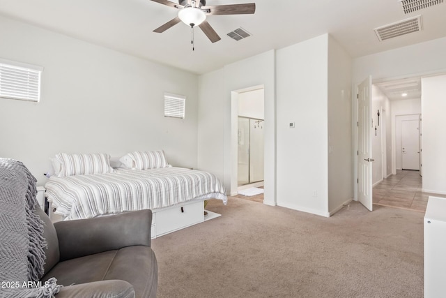 carpeted bedroom with ceiling fan and ensuite bathroom