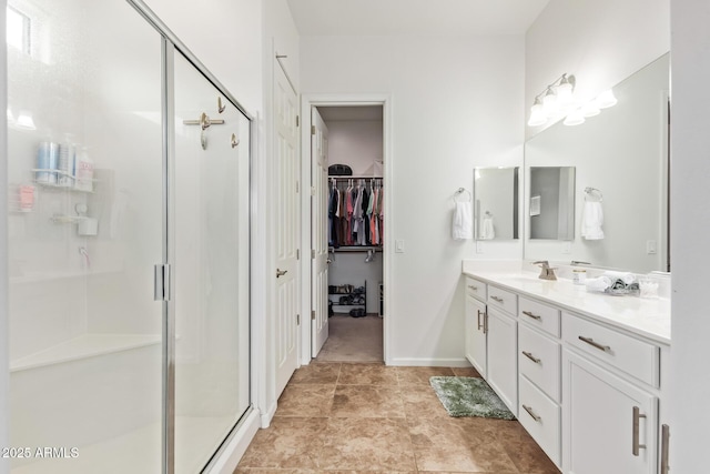 bathroom featuring an enclosed shower and vanity