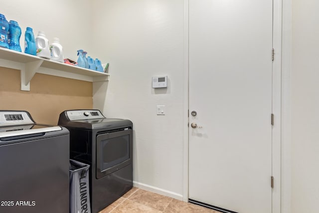 washroom featuring separate washer and dryer and light tile patterned floors