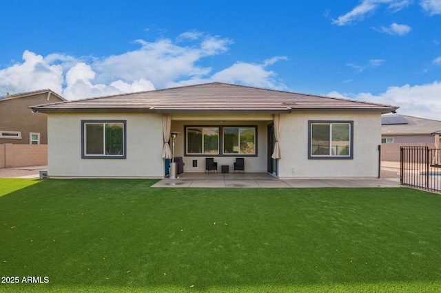 back of property with a patio and a yard