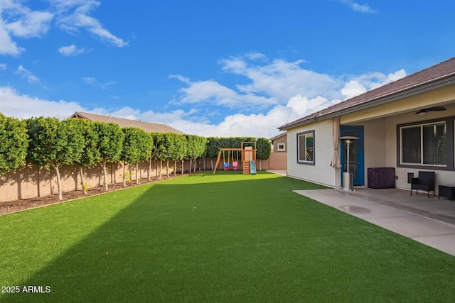 view of yard with a playground and a patio area