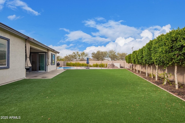 view of yard with a fenced in pool and a patio area