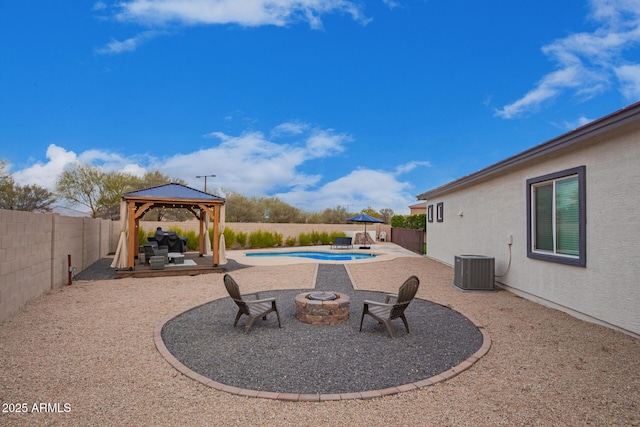 view of swimming pool with a gazebo, a patio, central air condition unit, and a fire pit