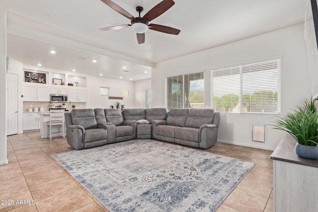 living room with ceiling fan and light tile patterned floors