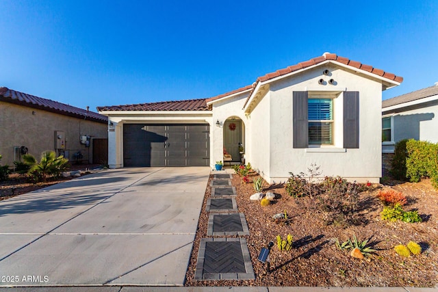 19756 W Roma Ave, Litchfield Park, AZ 85340 - mediterranean / spanish home with stucco siding, a tiled roof, concrete driveway, and a garage
