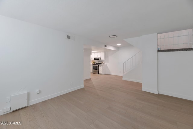 spare room featuring light hardwood / wood-style flooring