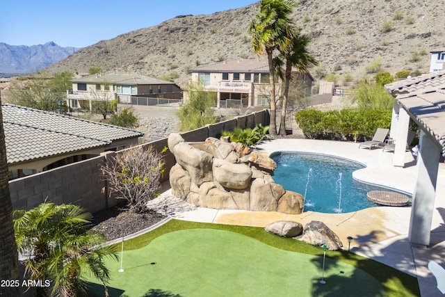 view of swimming pool with a mountain view, a patio, a fenced in pool, and a fenced backyard