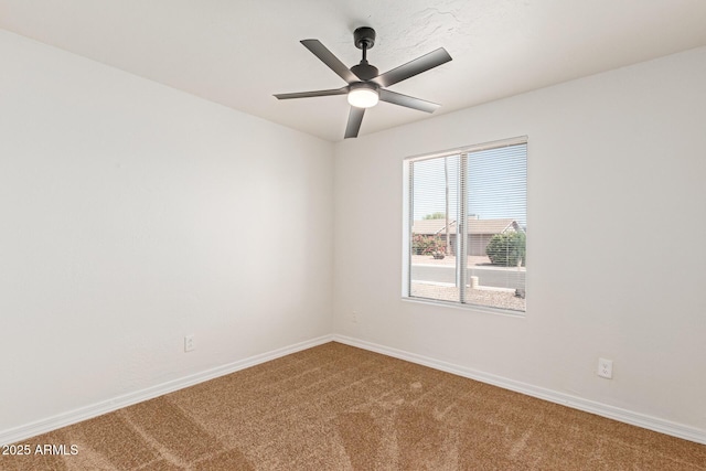 spare room with carpet and ceiling fan