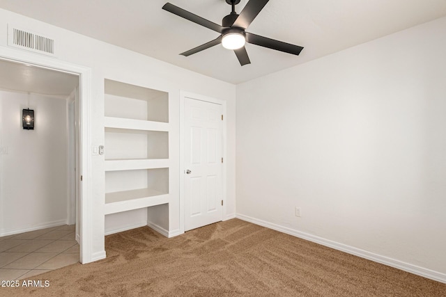 unfurnished bedroom featuring carpet flooring, ceiling fan, and a closet