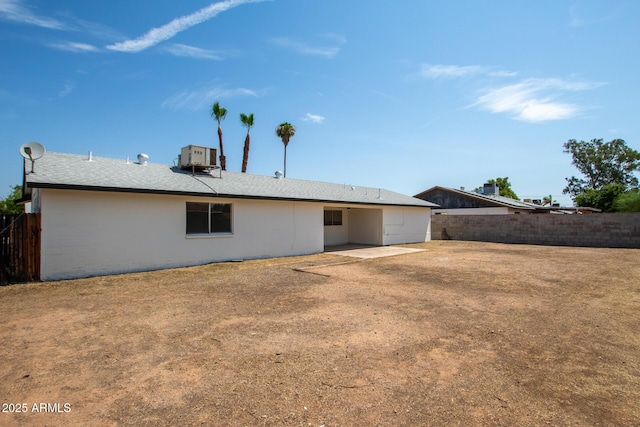 rear view of property featuring cooling unit