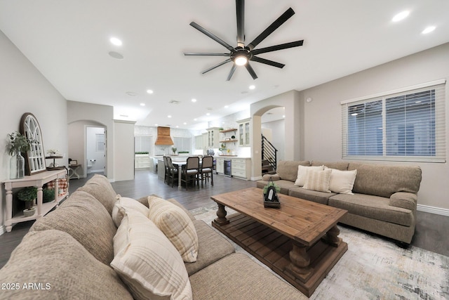 living room featuring ceiling fan and hardwood / wood-style floors