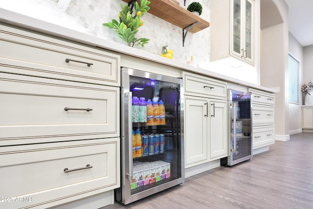 kitchen with wine cooler, light hardwood / wood-style flooring, and cream cabinetry