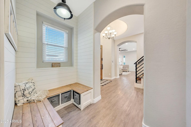 mudroom featuring wooden walls and light hardwood / wood-style floors