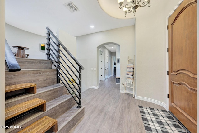 foyer with an inviting chandelier and light wood-type flooring