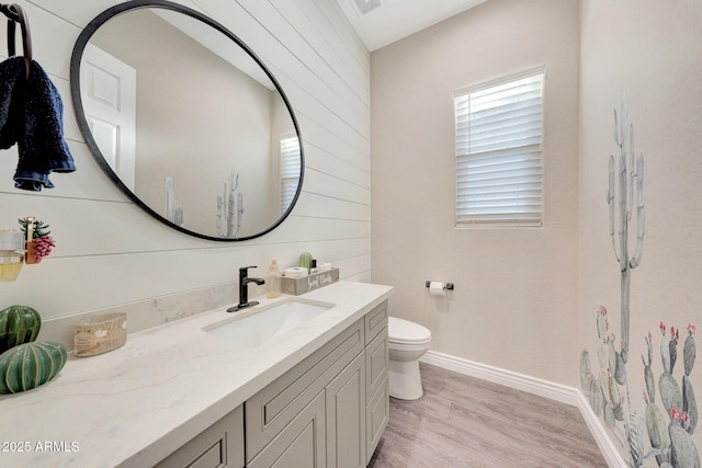 bathroom featuring vanity, hardwood / wood-style floors, and toilet