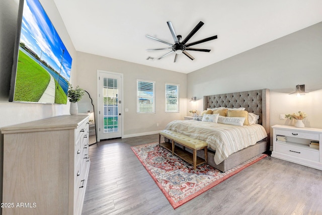 bedroom with hardwood / wood-style floors, access to outside, and ceiling fan